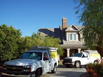 AAA Bee Removal company trucks in a driveway